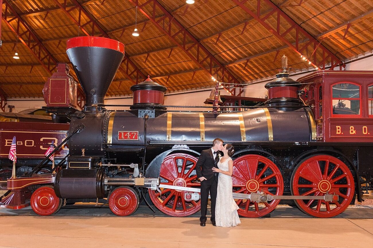 Wedding couple beside a historic locomotive at the B&O Railroad Museum