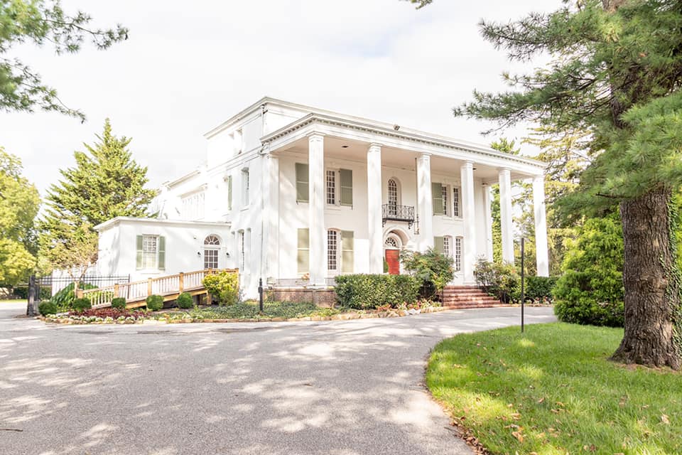 Grey Rock Mansion and its landscaped grounds in Pikesville