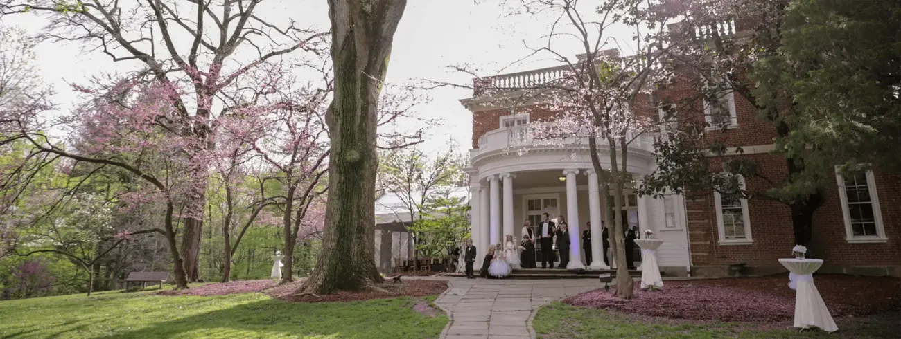 Woodend Mansion surrounded by trees in its nature sanctuary